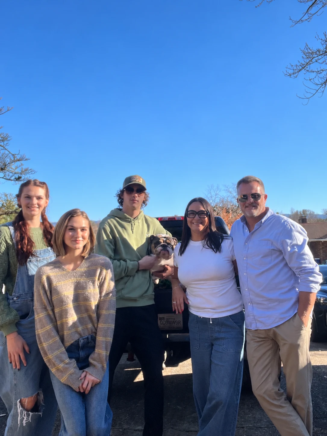 Brandon Thomas and his family with their dog outdoors